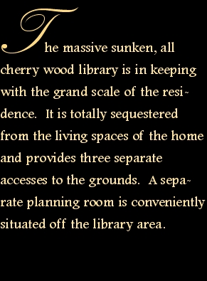 The massive sunken, all cherry wood library is in keeping with 