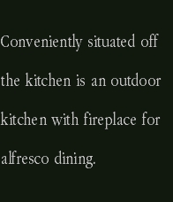 Conveniently situated off the kitchen is an outdoor kitchen wit